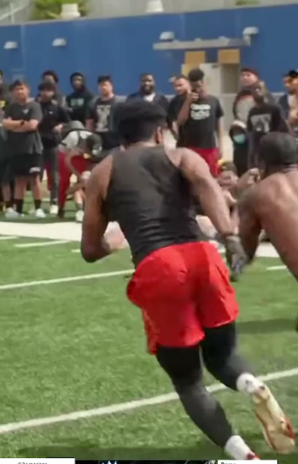Rome Rizzo at a one-on-one football rep while a crowd watches