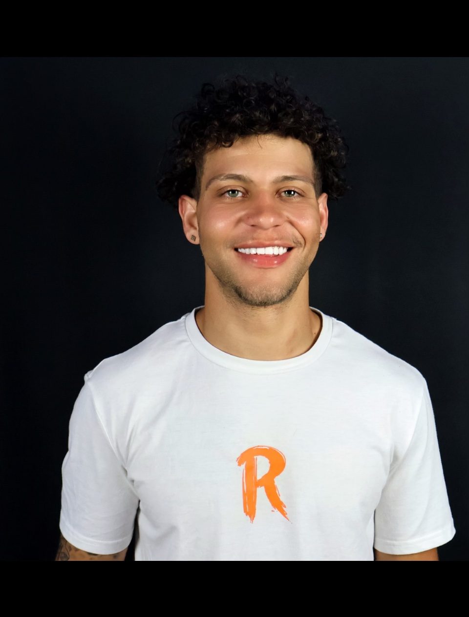 Studio headshot of Rome Rizzo in a white T-shirt