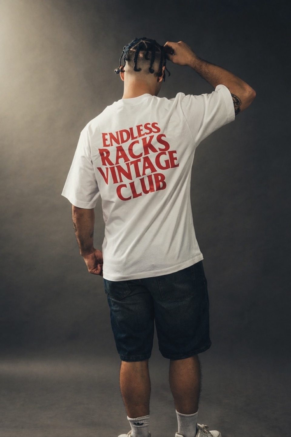 Back-view studio modeling shot of Rome Rizzo showing a graphic T-shirt print for Endless Racks Vintage Club
