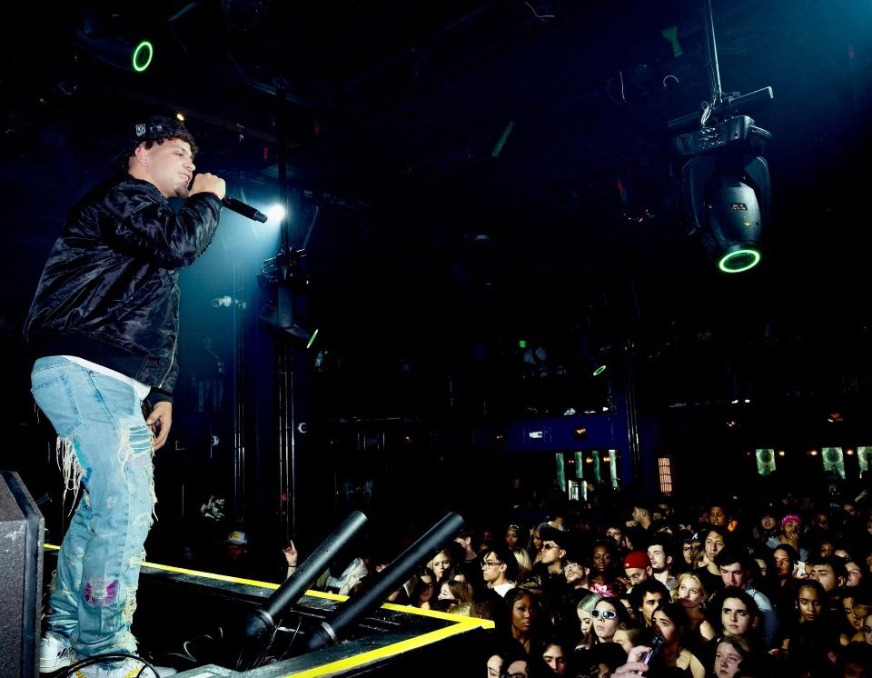 Rome Rizzo performing on stage in front of a large crowd